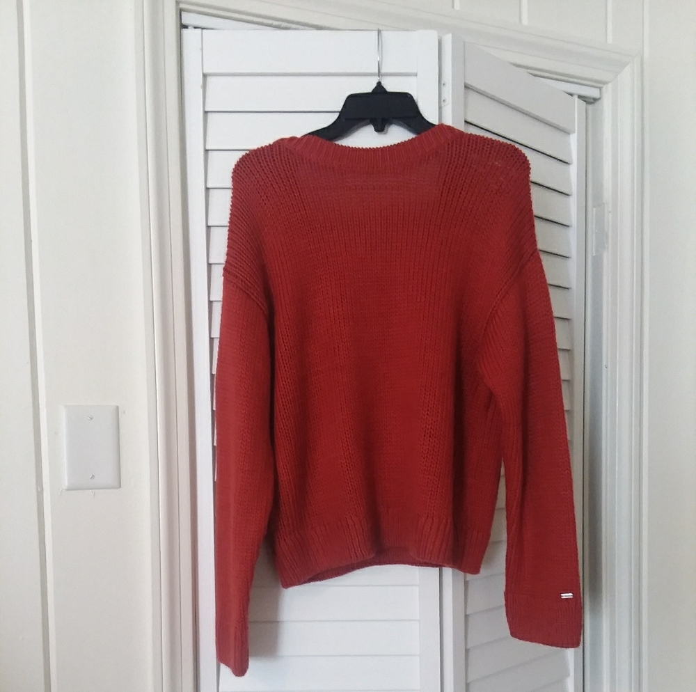 A dark orange sweater
